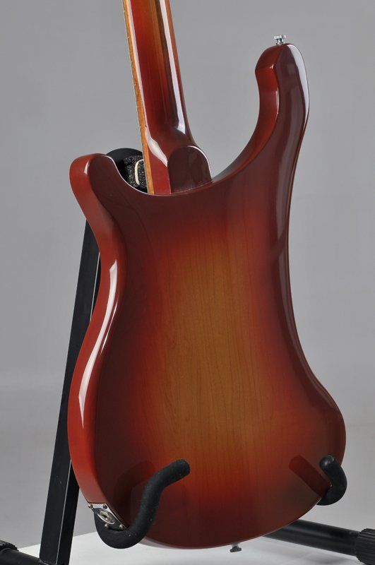 The back of a guitar is shown on a stand