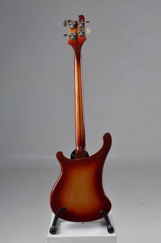 The back of a bass guitar is shown on a stand.