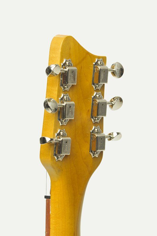 A close up of a guitar headstock on a white background