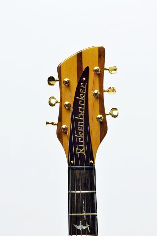 A close up of the headstock of a rickenbacker guitar