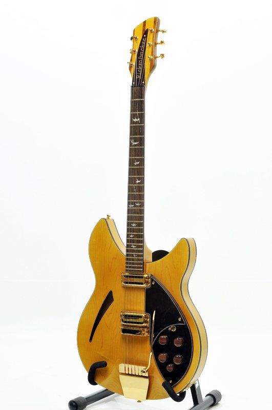 A guitar is sitting on a stand on a white background