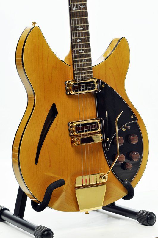 A guitar is sitting on a stand that says ' fender ' on it