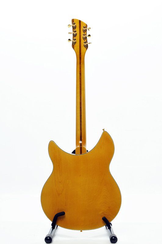 The back of a yellow electric guitar on a stand