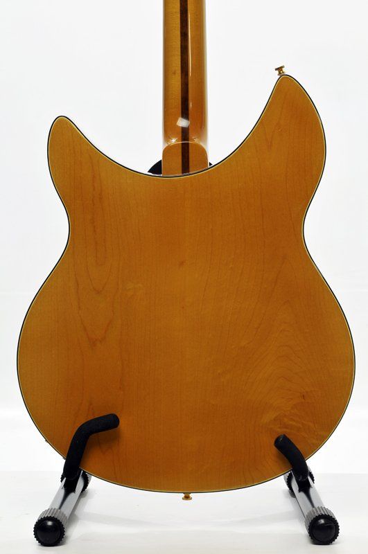 The back of a guitar is shown on a stand
