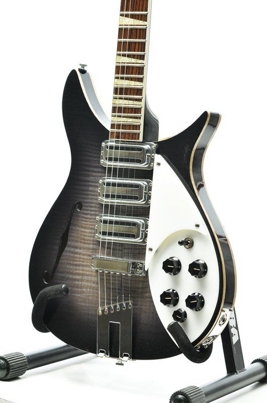 A black and white electric guitar on a stand