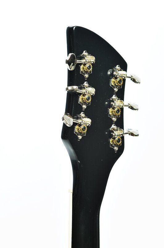 A close up of a guitar headstock on a white background.