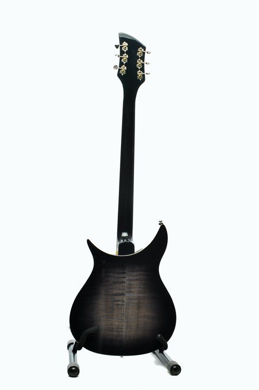 A black electric guitar is sitting on a stand on a white background.