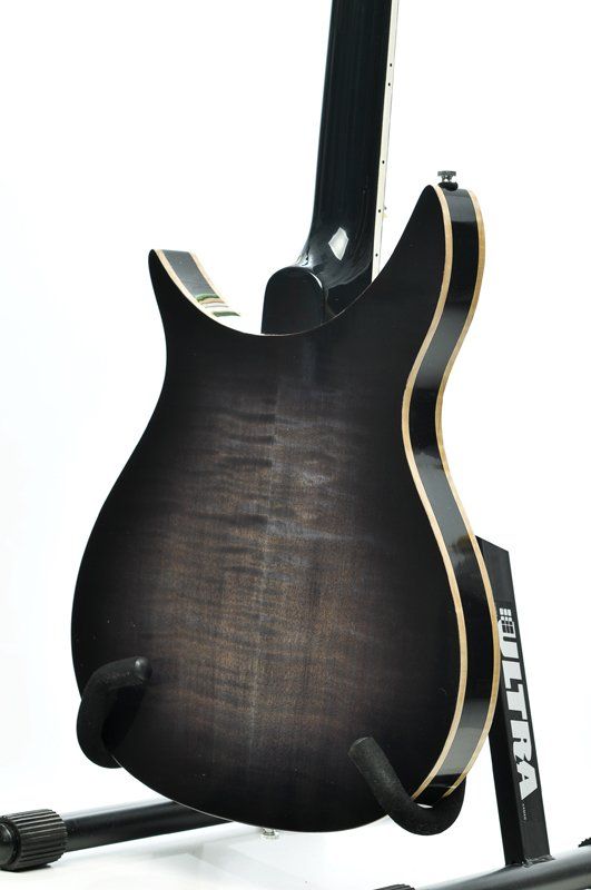 A guitar is sitting on a stand that says ultra