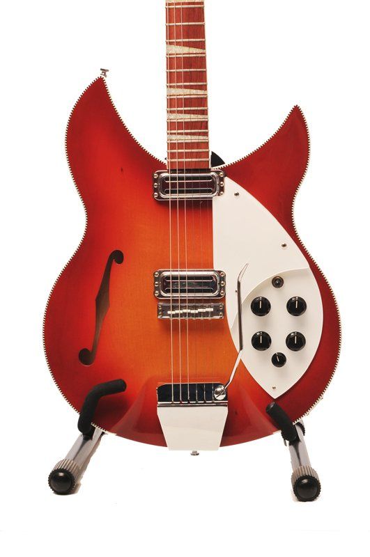 A red and orange guitar is sitting on a stand