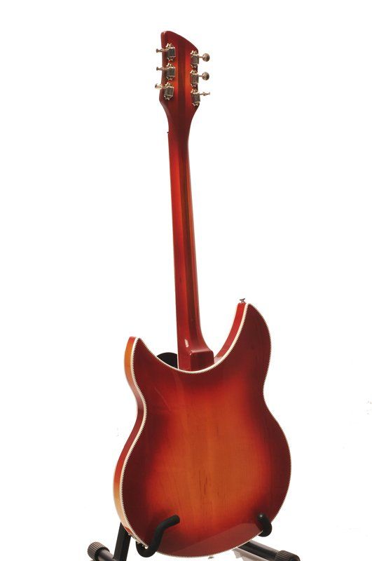A red guitar is sitting on a stand on a white background