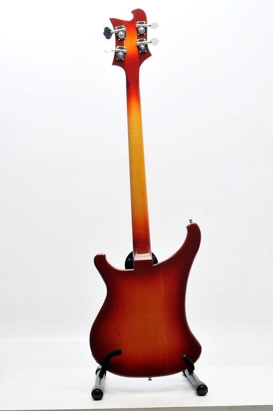 The back of a red and yellow electric guitar on a stand