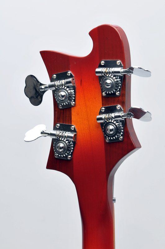 A close up of the headstock of a bass guitar
