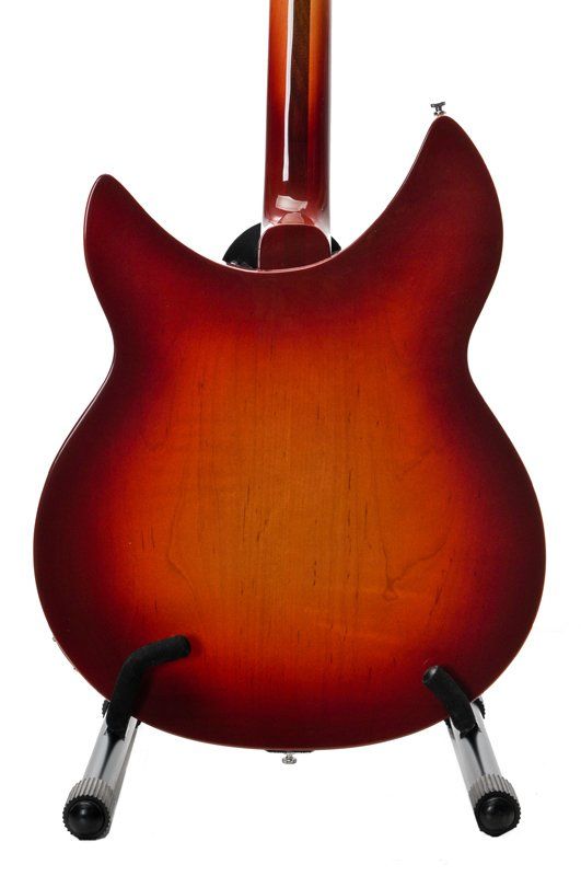 A red guitar is sitting on a stand on a white background