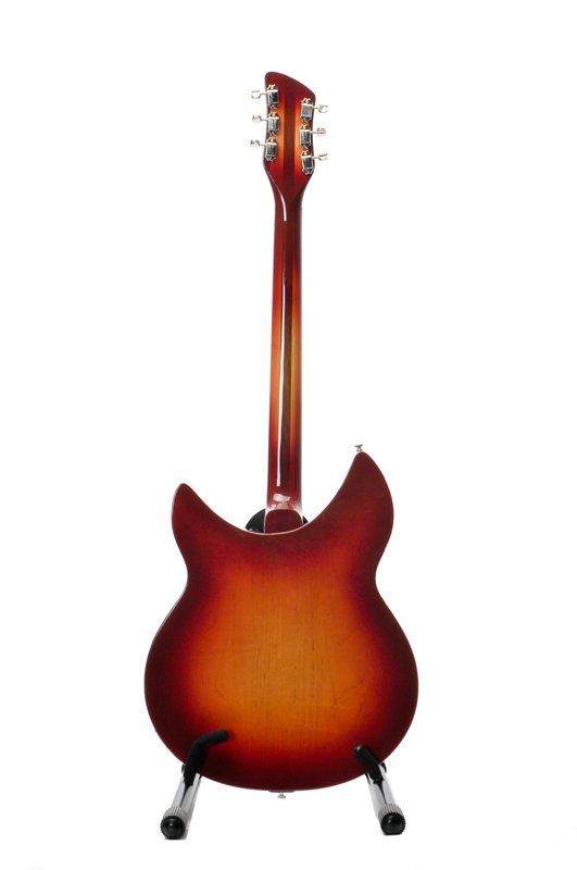 A red electric guitar is sitting on a stand on a white background.