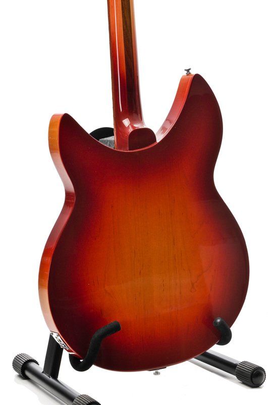 The back of a red electric guitar on a stand