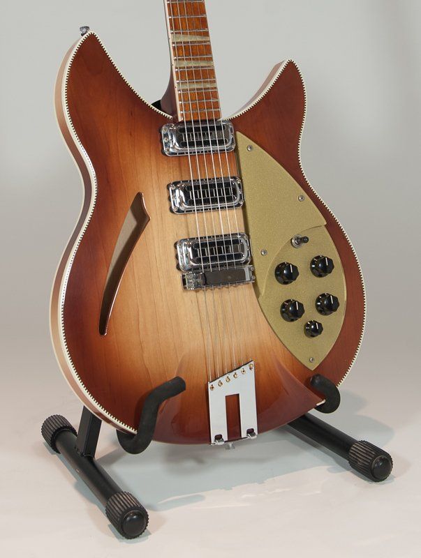 A guitar is sitting on a stand with the letter n on it