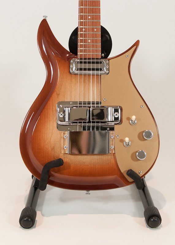 A guitar is sitting on a stand on a white background