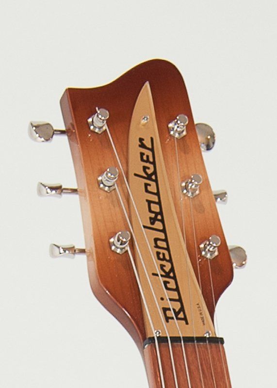 A close up of a rickenbacker guitar headstock