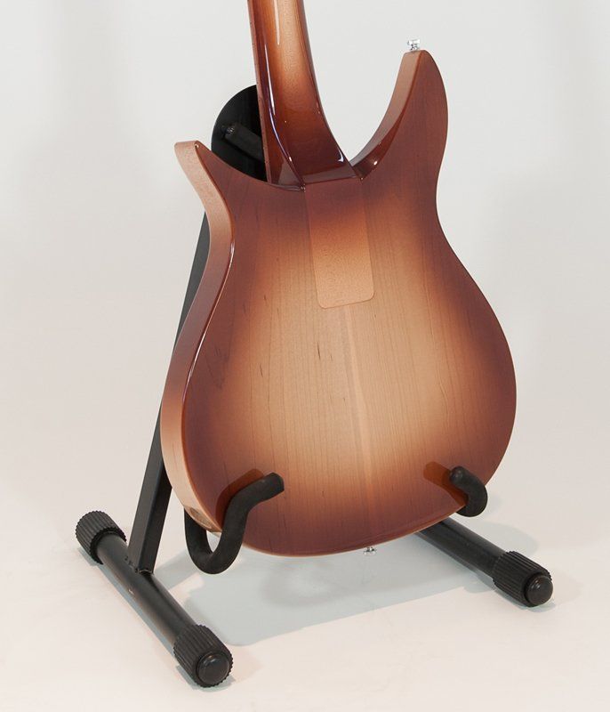 The back of a guitar is shown on a stand