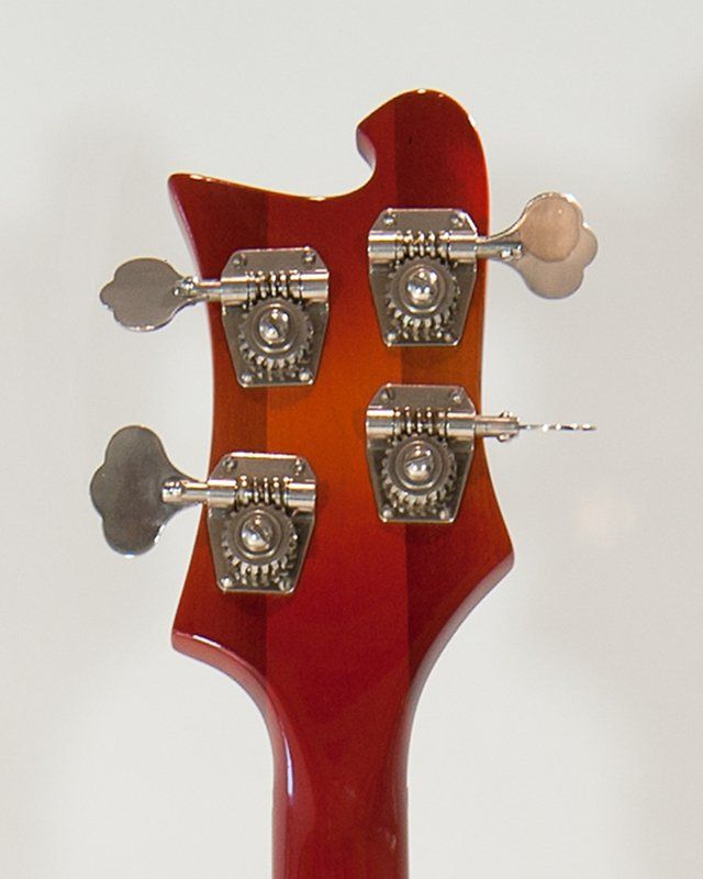 A close up of the headstock of a bass guitar