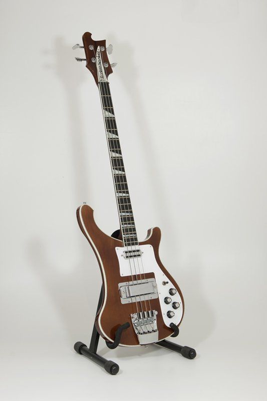 A brown and white electric guitar on a stand