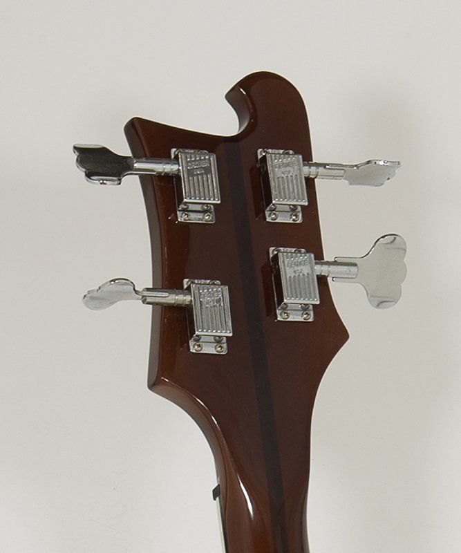 A close up of the headstock of a bass guitar