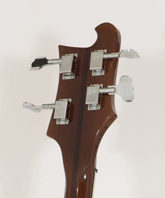 A close up of the headstock of a bass guitar