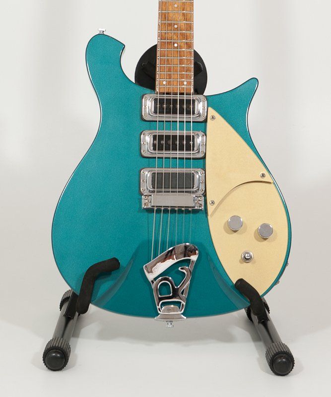A blue electric guitar is sitting on a stand