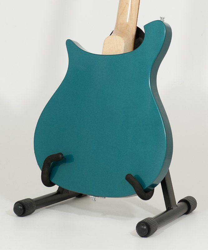 A blue guitar is sitting on a black stand