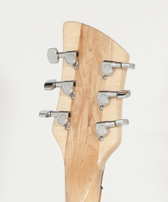 A close up of a guitar headstock with chrome tuners