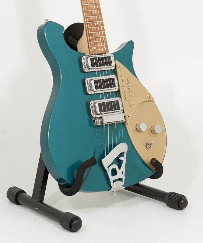 A blue electric guitar is sitting on a stand