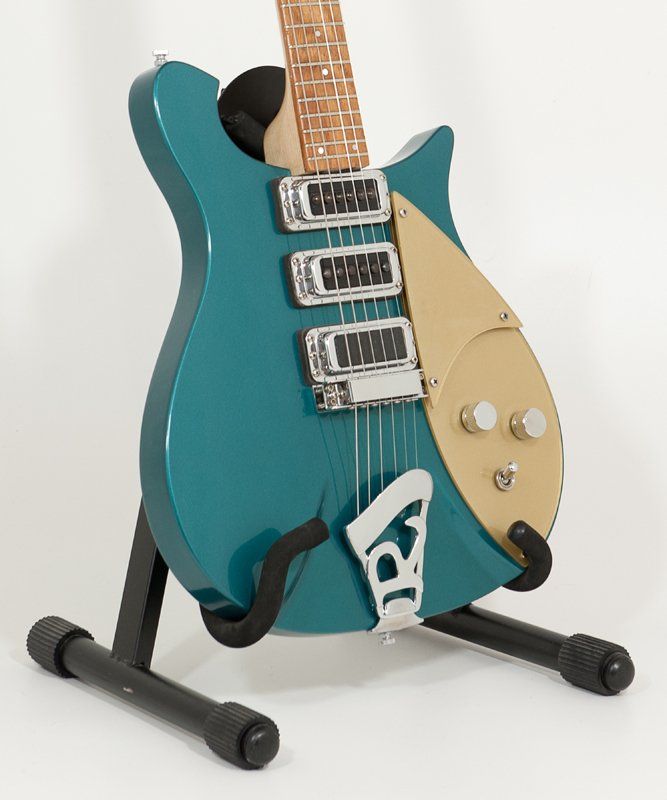 A blue and gold electric guitar is sitting on a stand