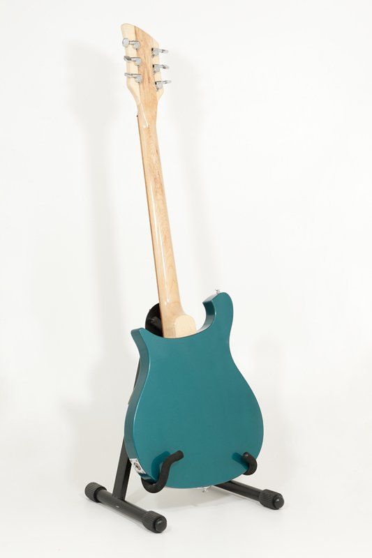 A blue electric guitar is sitting on top of a guitar stand.
