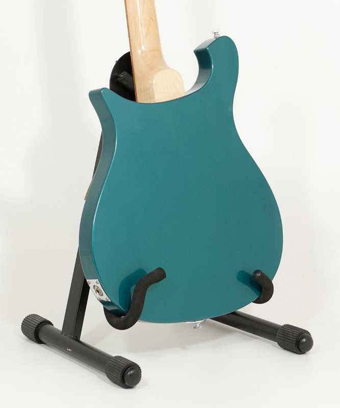 A blue guitar is sitting on a black stand