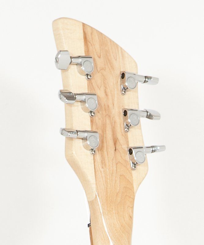 A close up of a guitar headstock with chrome tuners