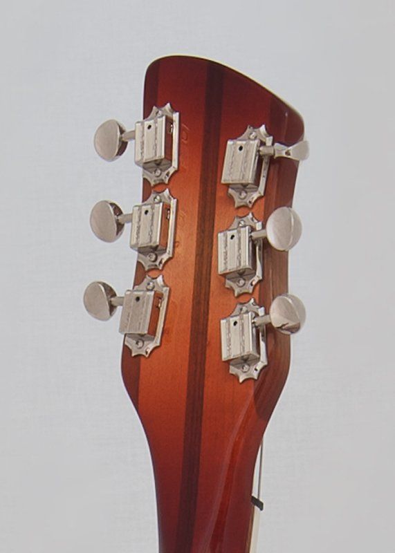 A close up of the headstock of an acoustic guitar
