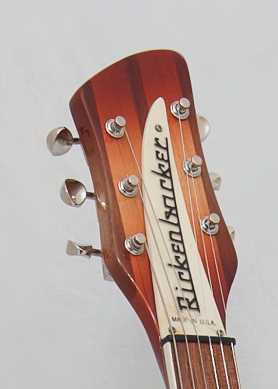 A close up of the headstock of a rickenbacker guitar