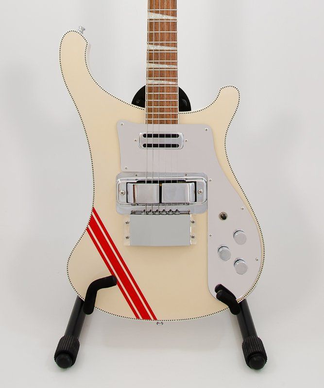 A white electric guitar with a red stripe on it