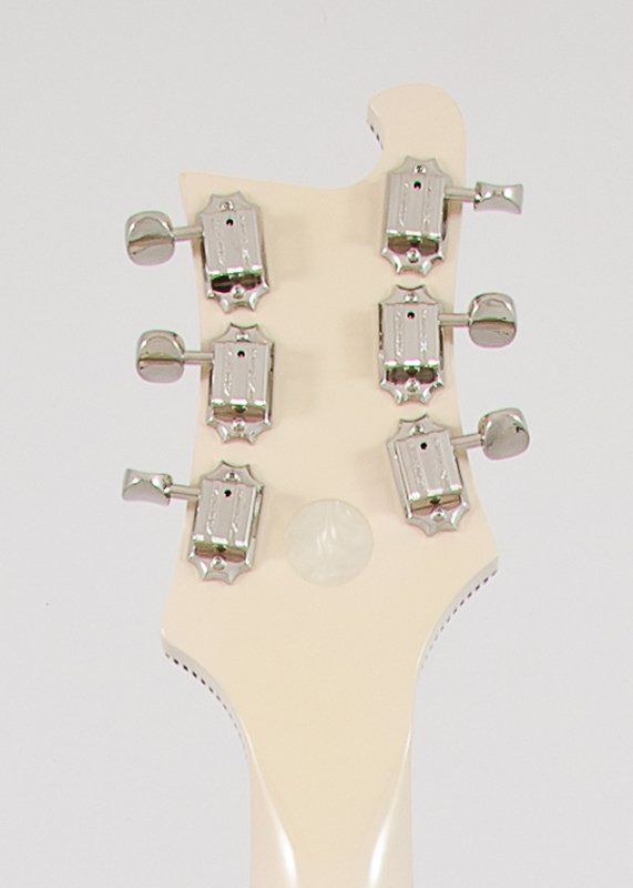 The headstock of a white electric guitar with chrome tuners