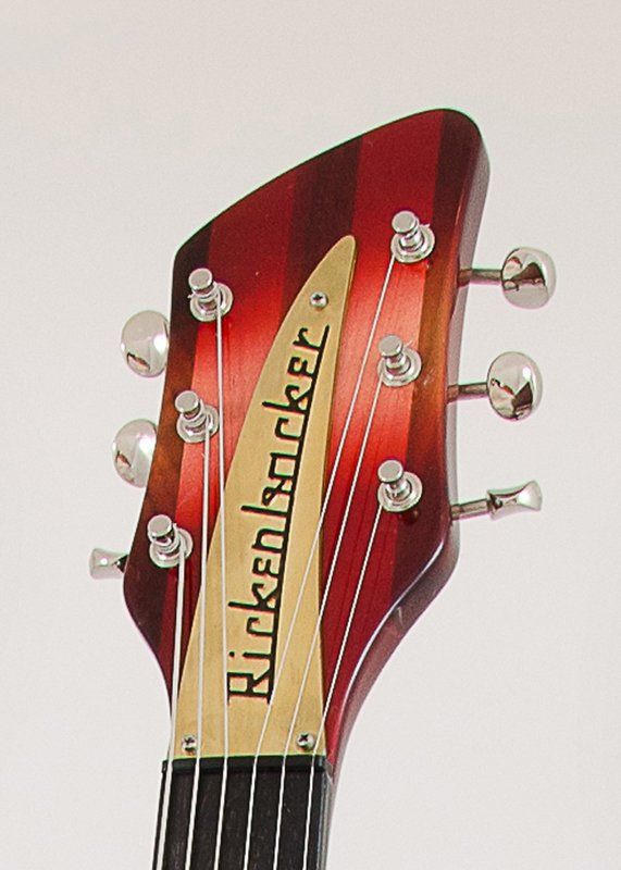 The headstock of a red rickenbacker guitar