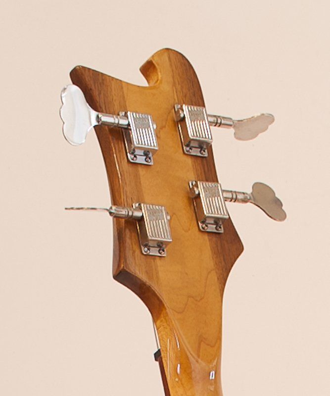 A close up of the headstock of a bass guitar
