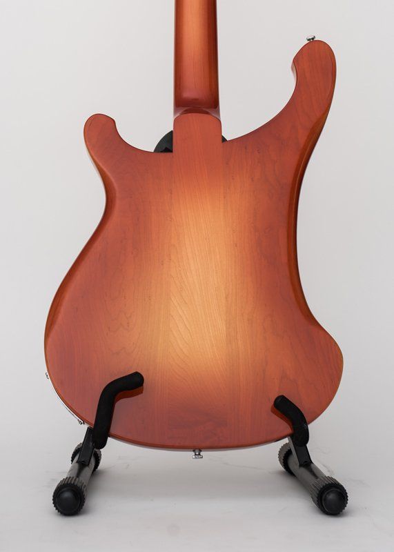 The back of a guitar is shown on a stand