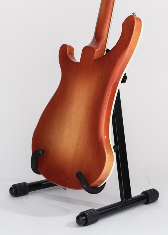 A guitar is sitting on top of a guitar stand