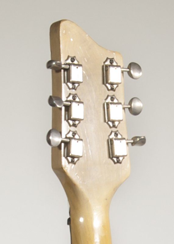 A close up of the headstock of a guitar