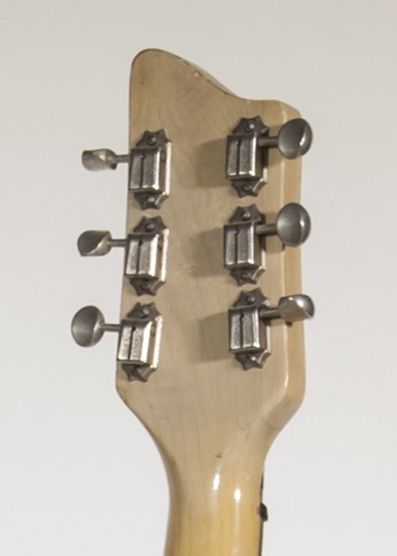 A close up of the headstock of an electric guitar