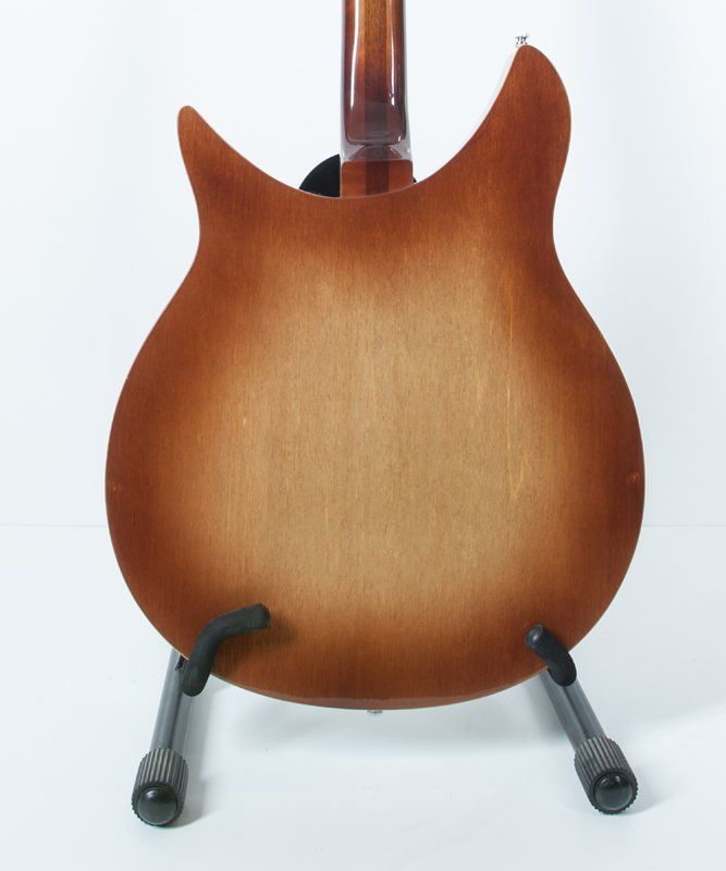 The back of a guitar is shown on a stand