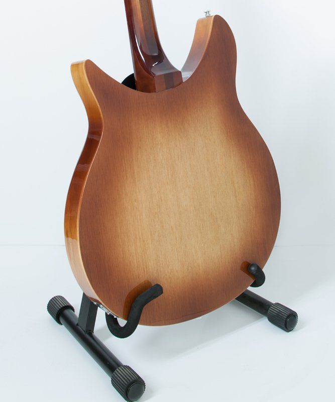 The back of a guitar is shown on a stand
