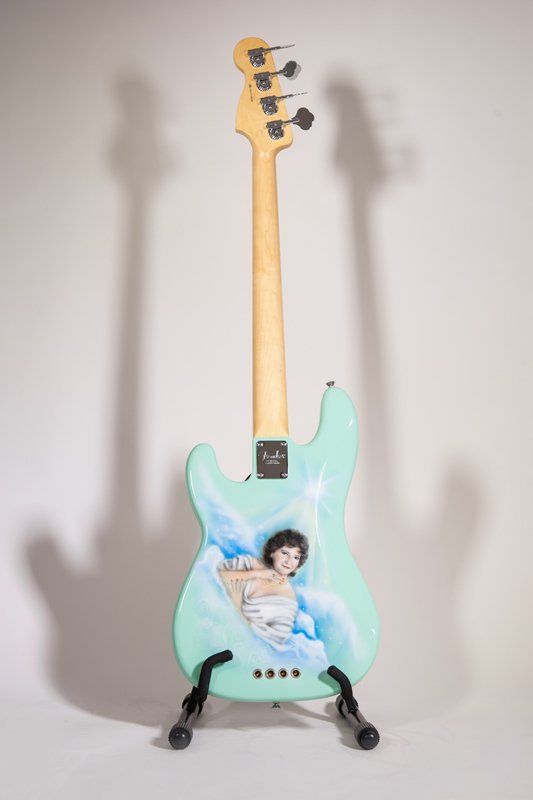 A guitar with a picture of a woman on it