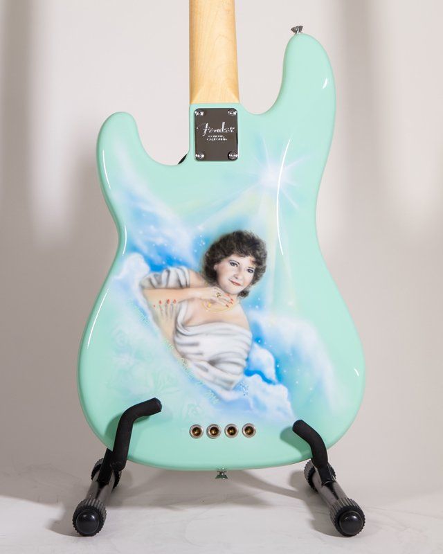 A guitar with a picture of a woman on it