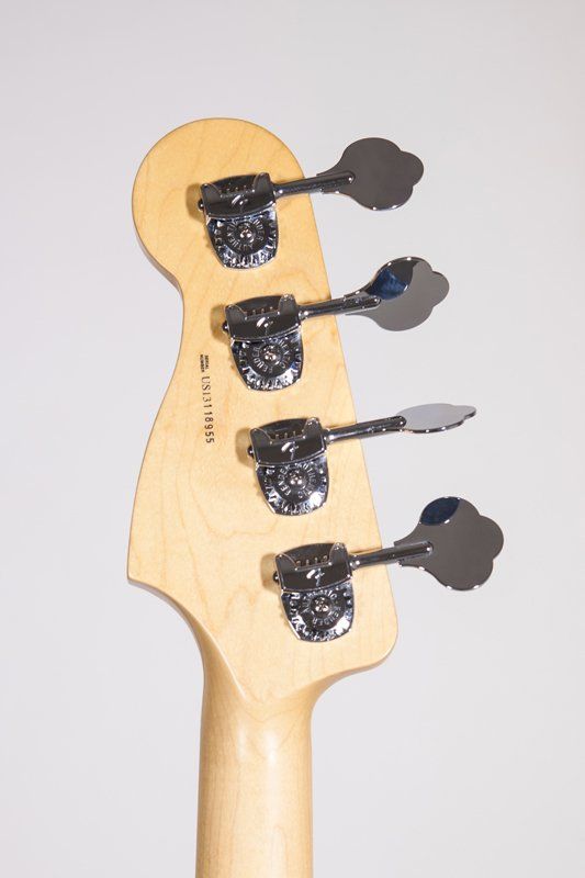 A close up of the headstock of a bass guitar